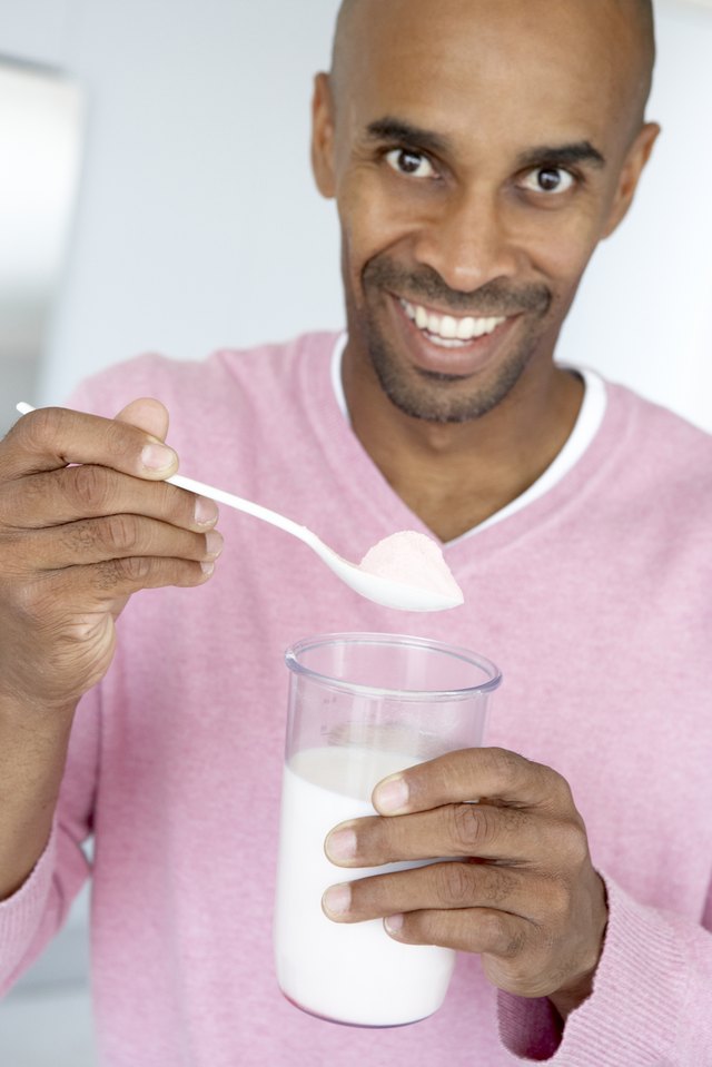 Man adding meal replacement powder to drink
