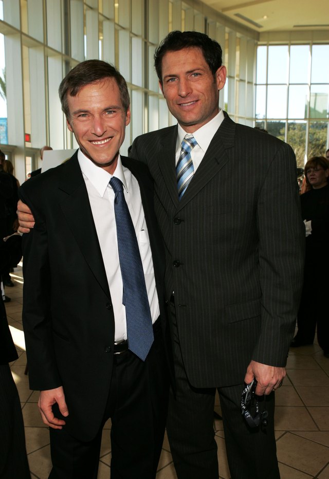 A former NFL quarterback poses for a photo with a sports agent.