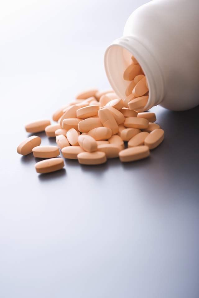 Vitamins spilling from bottle.
