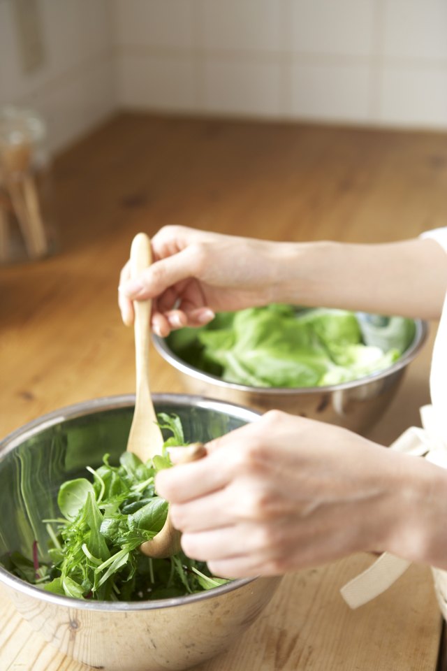 A woman is preparing a healthy salad.