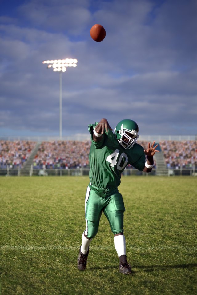 Quarter back throws ball