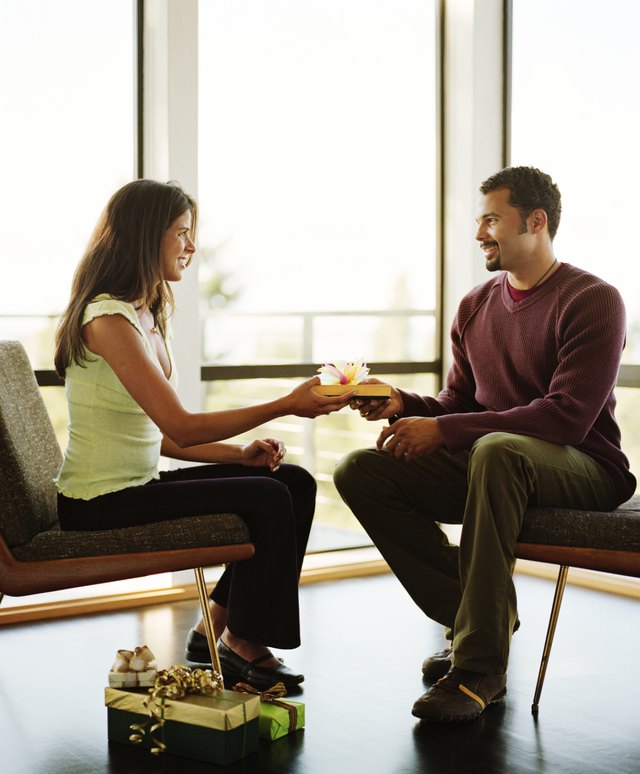 A man and woman are exchanging gifts. A man and woman are exchanging gifts.
