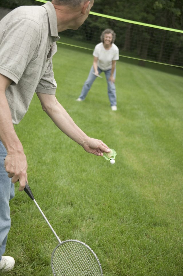 A badminton player gets ready to hit a low serve.