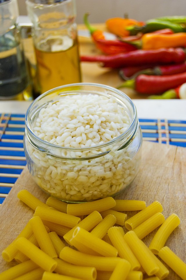 A jar of cooked rice on the kitchen counter.