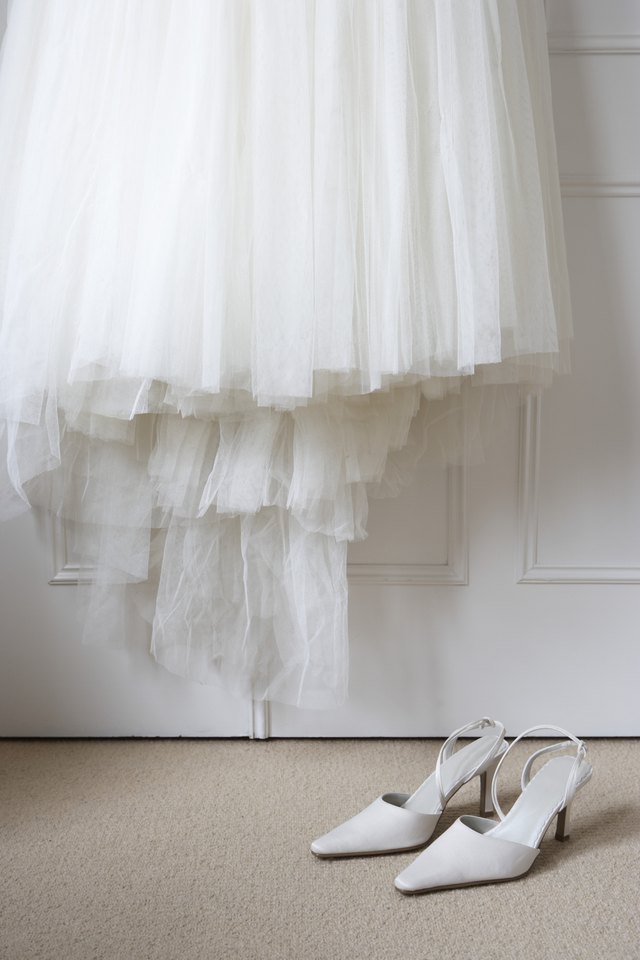 A detachable wedding skirt adds drama to a short wedding dress.
