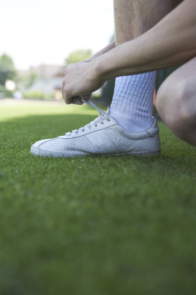 Clean white sneakers with shaving cream to keep them white.
