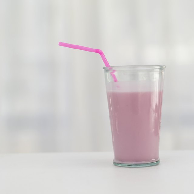 Pink milkshake sitting on counter