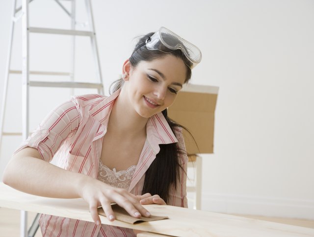 A woman uses sand paper