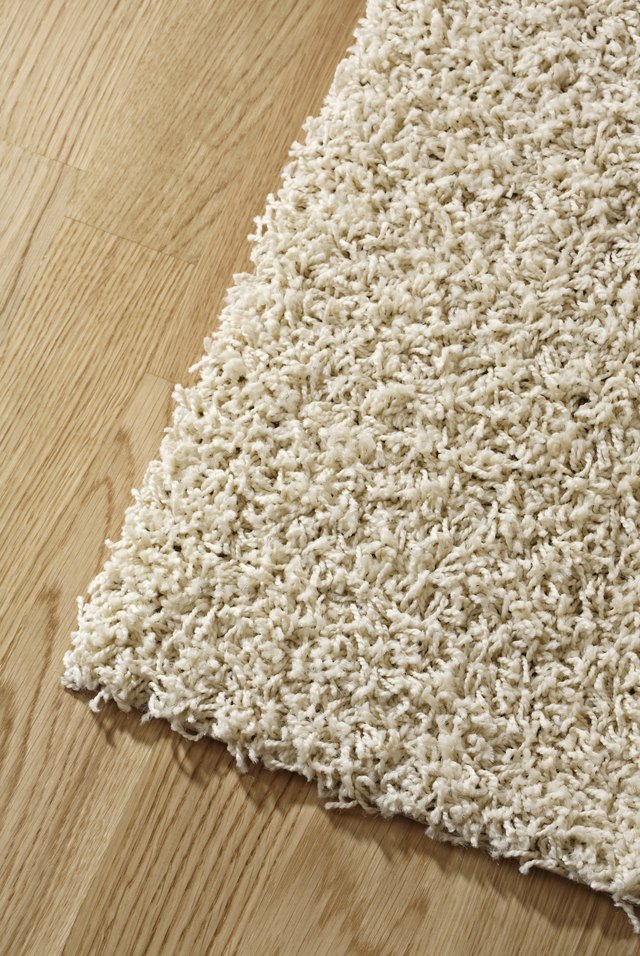 A plain wood under thick textured rugs or bamboo mats.