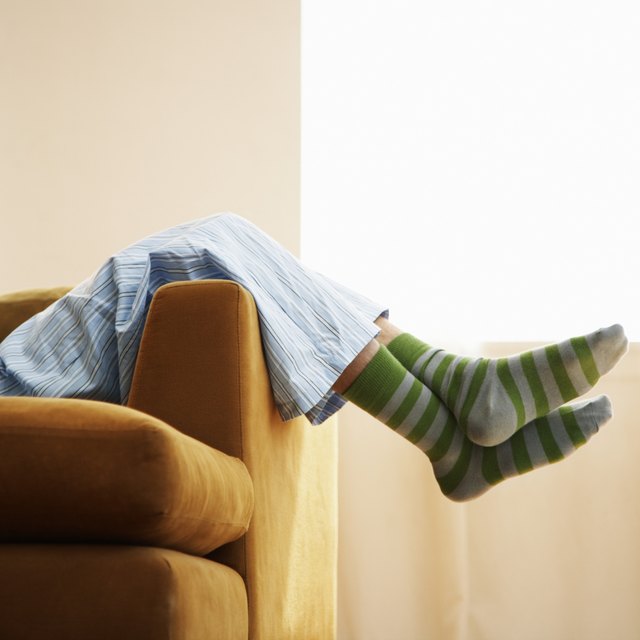A close-up of a person relaxing on a couch. A close-up of a person relaxing on a couch.