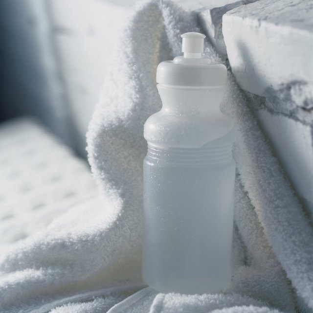 Clean fabric Coach purses with a white towel, water and recommended cleanser.