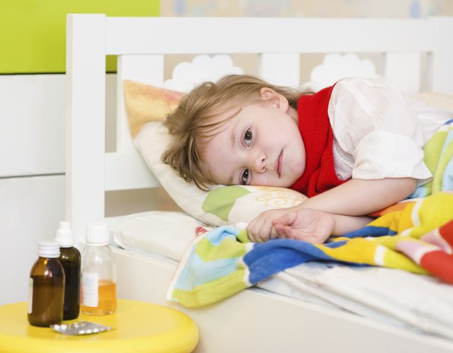 A sick girl lies in bed. A sick girl lies in bed.