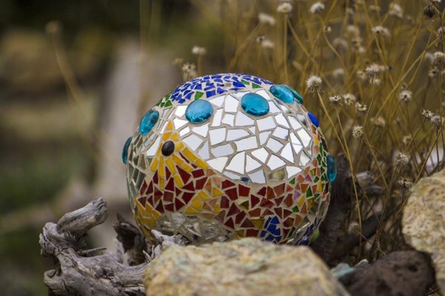 Create a quirky mosaic orb out of a bowling ball and broken tiles.