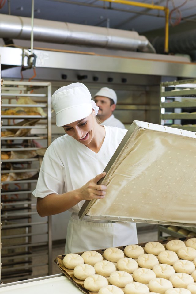 Baker preparing dough for oven