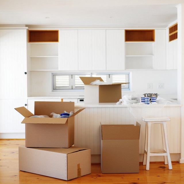 A stack of packed boxes in a nearly empty kitchen