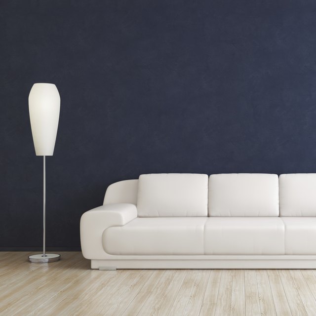 A white leather sofa in a modern living room. A white leather sofa in a modern living room.