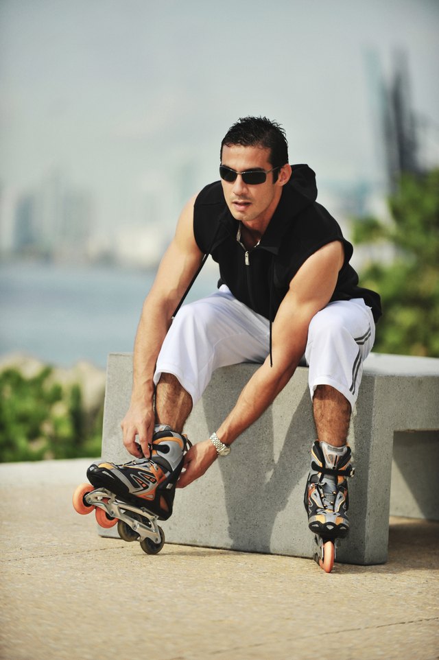 Man putting on in-line skates