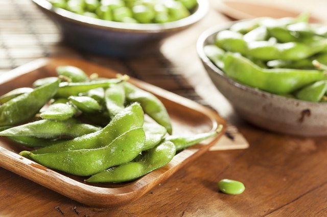 Cooked edamame in small bowls.