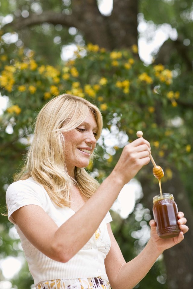 woman holding honey jar woman holding honey jar