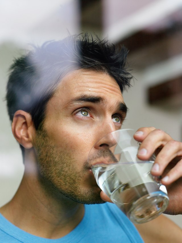 Man drinks glass of water