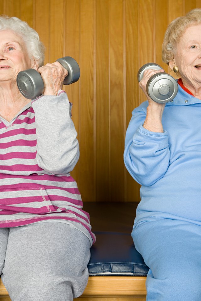Two mature woman lift light weights