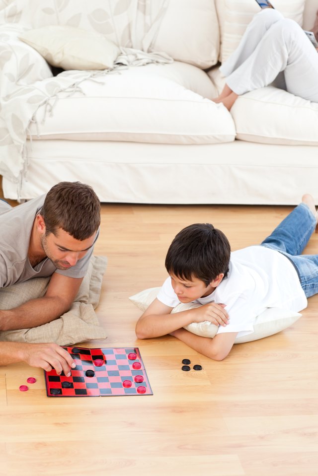 Father and son playing checkers