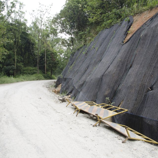 Landslide prevention is set set-up alongside a road in an area affected by an earthquake.