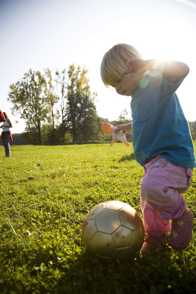 Child kicking soccer ball