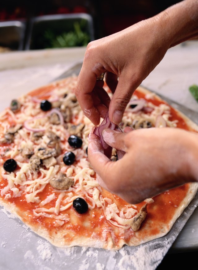 Toppings going on pizza