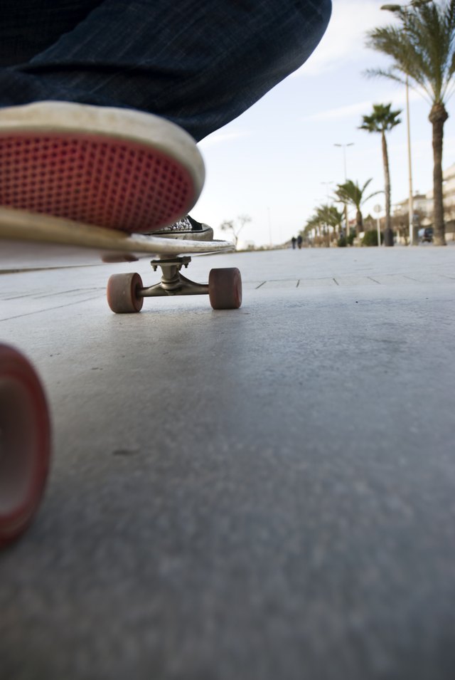 A close-up of a skater riding along the promenade.