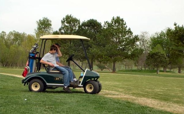 Driving a golf cart.