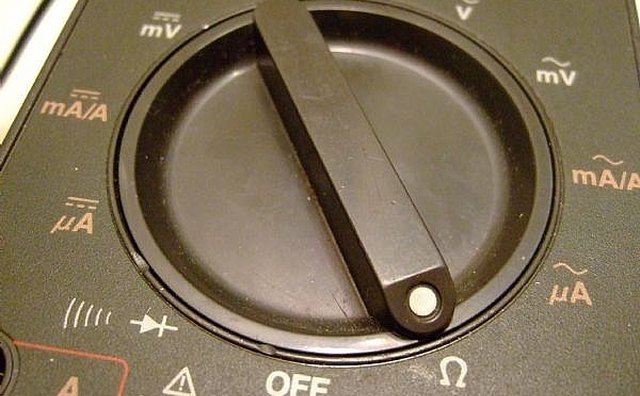 Set the dial for Ohm test