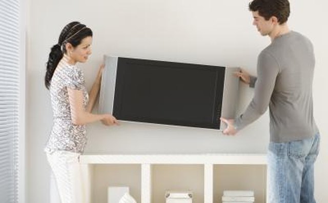 technician helping woman with home theater set up