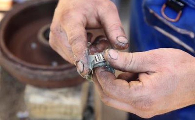 Mechanic lubricates wheel bearing