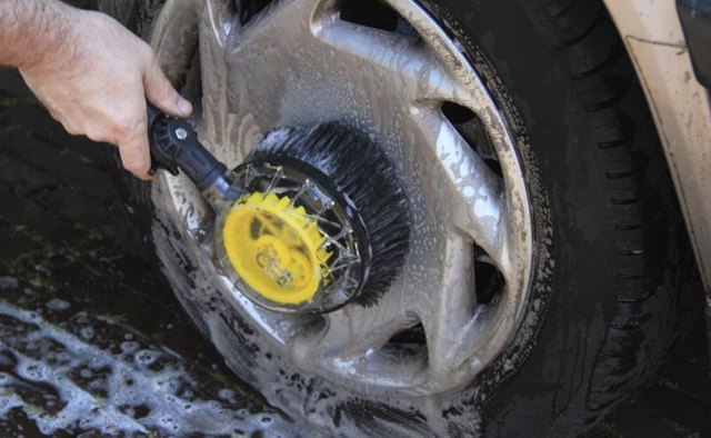 Use a stiff scrubbing brush to scrub off the tar.