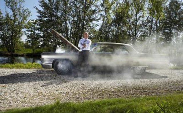 Smoke coming from under the hood may indicate a faulty starter.