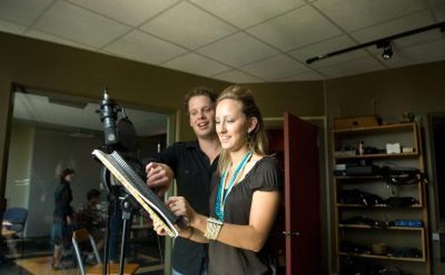 2 people in a recording studio.