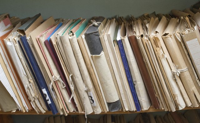 A close-up of a shelf of archived paperwork.