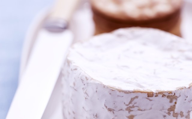 Slice the top rind off of the brie, leaving the rind on the sides.