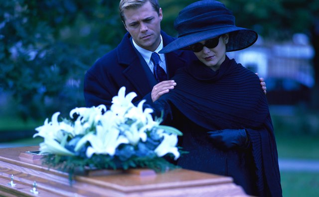 Women attending funeral masses may wear dark, tasteful hats.