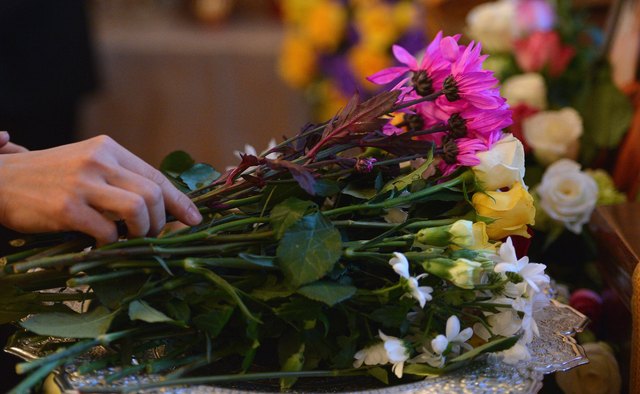 Mourners arrange an altar around the casket to honor the deceased.