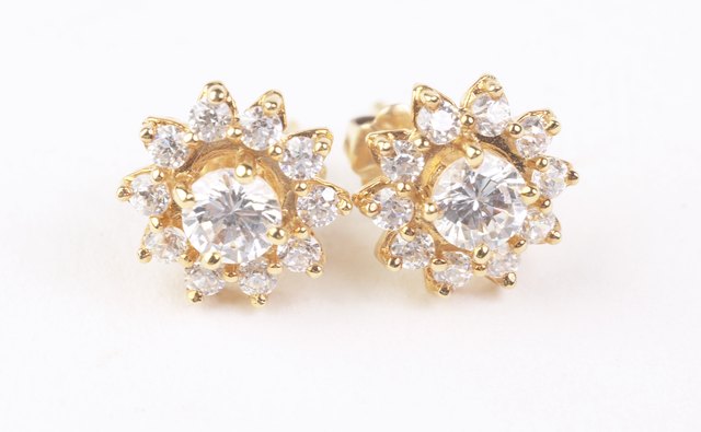 A simple pair of diamond studs accent your silver dress without pushing the sparkle over the top.