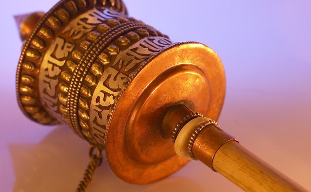 This small Tibetan prayer wheel has the words of a prayer embossed on its surface.