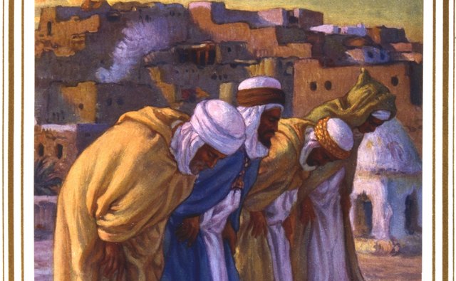 Men follow an imam in prayer.