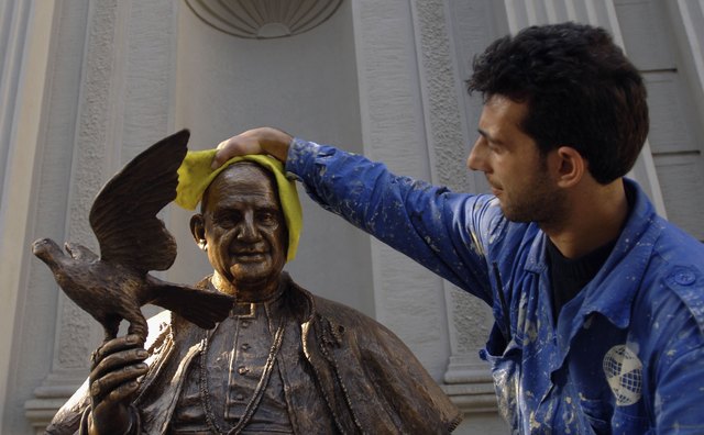 In Istanbul a worker cleans a statue of Pope John XXIII, father of Vatican II.