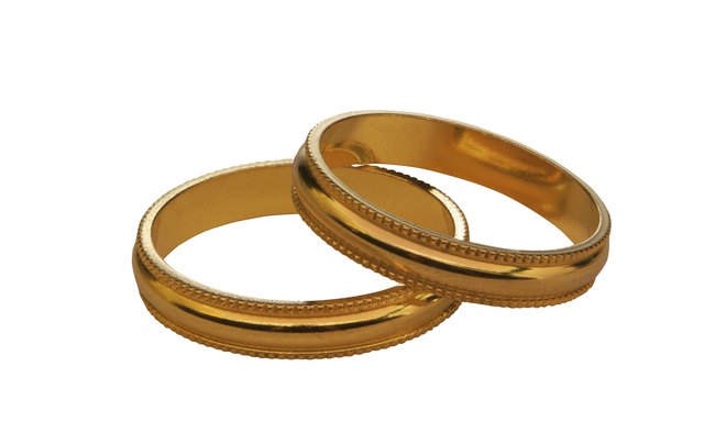 Try a nice pair of gold bangles to add some contrast with your silver dress.