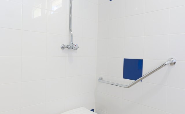 Foldable bath aid chair in shower