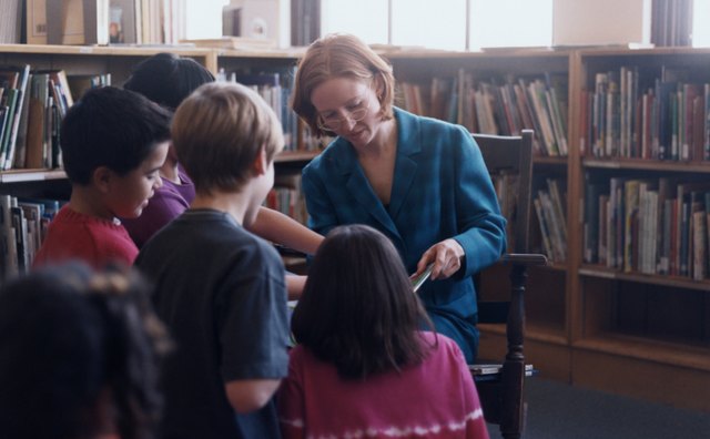 Librarian reading to elementary students