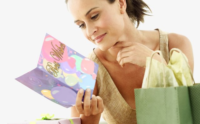 A woman is reading her card.