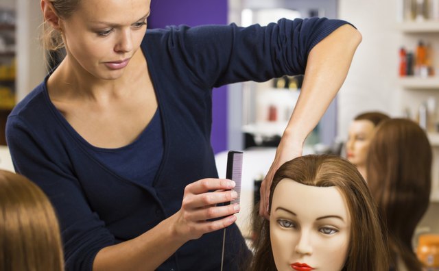 An apprentice practices on a mannequin.